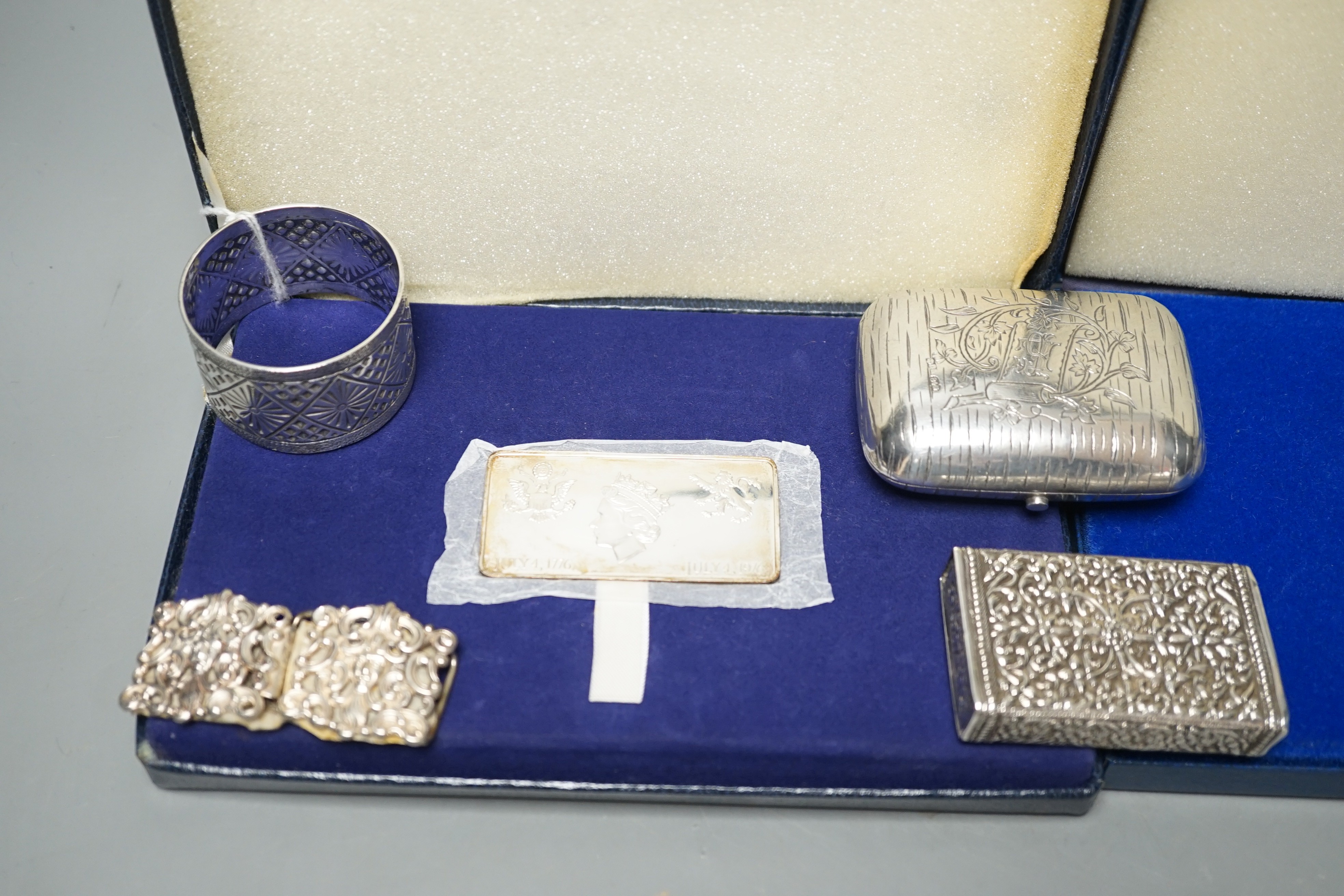 Small silver items including two napkin rings, a modern cased commemorative plaque and replica stamp, together with four white metal items including a Russian mounted purse.